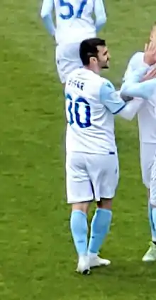 The player smiling during a goal celebration