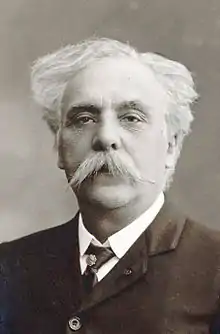 Elderly white man with large white moustache and luxuriant white hair