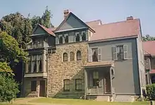 A large three-story house of wood and stone