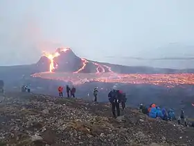People on the slopes of Fagradalsfjall, watching the Geldingadalir eruption.