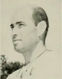 Black and white photograph of a white man, shot from the neck up