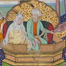 Painting of an old woman with golden dress and white headscarf on a balcony next to an old man wearing a green tunic and a white turban