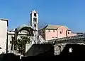 The ruins of Santa Maria in Passione and the former monastery of S. Maria delle Grazie "la Nuova" (the pink building on the left)