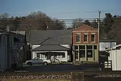 Railroad tracks in the foreground as some of Georgetown's original architecture is seen along Highway 64.