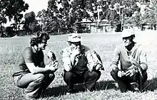 Three men with Eurasian sparrowhawks perching on their fists