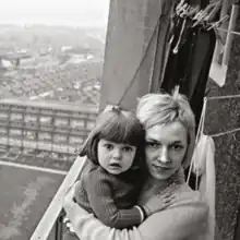 A black-and-white photo of a woman cradling a child