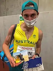 Ari holding photo of his father