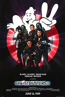 Bill Murray, Dan Aykroyd, Harold Ramis, and Ernie Hudson face the viewer. They are armed with slime throwing weapons resembling guns, with large tanks on their back. Behind them is a large logo of a "no ghosts" sign holding up two fingers. The logo "Ghostbusters II" is printed beneath them.