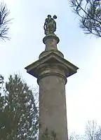 The top of the column, the figure seen from behind.