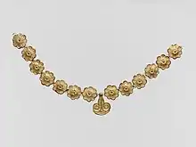 Necklace; 1400-1050 BC; gilded terracotta; diameter of the rosettes: 2.7 cm, with variations of circa 0.1 cm, length of the pendant 3.7 cm; Metropolitan Museum of Art