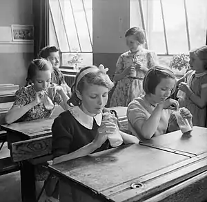 Girls at Baldock County Council School in Hertfordshire enjoying a drink of milk during a break in the school day in 1944