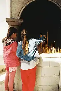 Girls lighting Candles at Monastery of Saint Johns