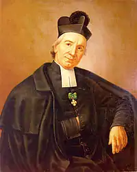 Saint Giuseppe Benedetto Cottolengo wearing the black biretta of a priest in a mid-19th century painting