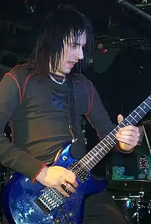 Butt playing guitar onstage