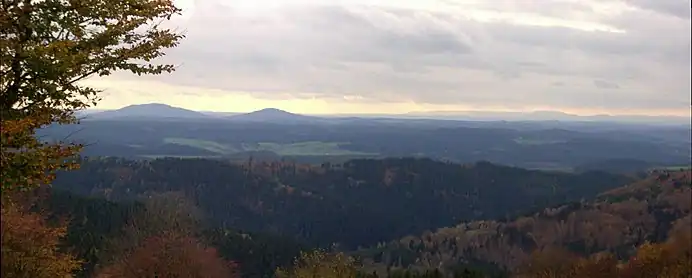 View of the Gleichberge (679 and 641 m), 24 km away. Right in the background is the High Rhön with the 928-m-high Kreuzberg 67 km away, immediately in front (centre half right) the 7-km-distant Ratscher Bergsee. In the foreground is the 621-m-high, Wachberg, 3 km away