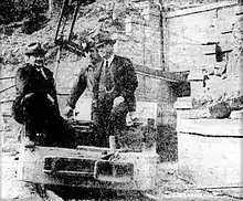 Sir George Davis (left) and Premier Mair (right, visiting Glen Davis in July 1940) aboard an electric locomotive, with mine adit at rear.