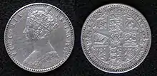 Both sides of a silver coin, with a crowned woman on one side and shields on the other