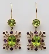 Gold earrings in suffragette colours