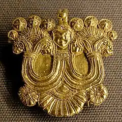 Gold pin figure Louvre