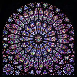 Notre-Dame de Paris, north rose window (1250s), typically Rayonnant: the glass area exceeds the round shape of the rose structure.