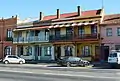 Row of four houses with unusual canterliever balconies, Goulburn.