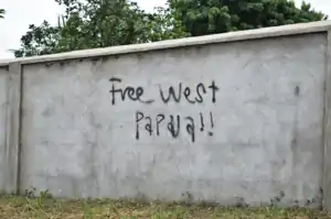 This is a photo of unlicensed graffiti in Vanuatu advocating for the liberation of West Papua. There is graffiti on a light-grey wall which says 'Free West Papua!!'. This photo reflects the international support for the self-determination of West Papuans.  This photo was taken in Vanuatu on 5 February 2018.