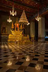 The Royal Nine-Tiered Umbrella (Nobapadol Mahasvetachatra) attached to a throne inside a hall in the Grand Palace, Bangkok. Only a crowned king can use an umbrella with nine-tiers, until then he must make do with only seven.