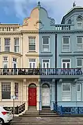 Street view of the cream and blue coloured houses of Grand Parade, Plymouth
