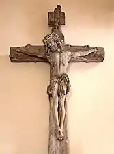 Photograph of a Christ on the cross hanging on a wall.