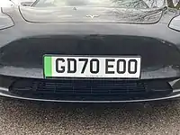 An example of the green band - on a Tesla - signifying the vehicle has zero emissions.