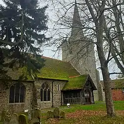 Stone church with a steep, mossy roof