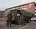 Greek soldiers guarding a truck carrying polling equipment for the 1996 Bosnian general election in Zenica