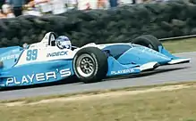A photograph of Moore driving on the Mid-Ohio Sports Car Course