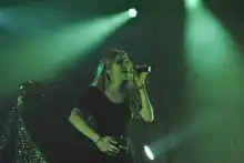 A photograph of Grimes performing live.