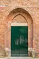 Side entrance in a masonry arch.