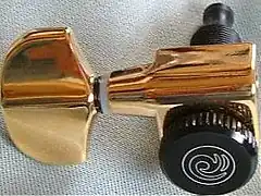 A closed machine head, detached from the instrument