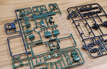 The left hand sprue includes parts molded in green, blue and transparent plastics