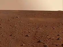 view of Martian desert showing rock field to the horizon