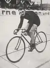 A male cyclist riding his bicycle on a track