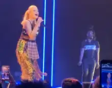 A color photograph of Gwen Stefani performing live.