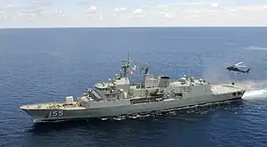 HMAS Ballarat with a US Navy helicopter in 2012