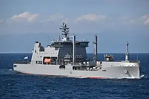 Colour photo of a grey ship at sea
