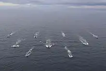 a group of warships at sea seen from high up