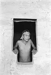 Emmett Harryson, a Navajo, at a T-shaped doorway at Balcony House (1929)