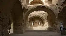 A room with well-built masonry walls and arches