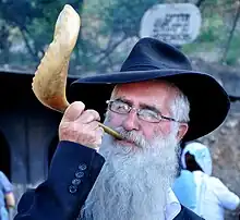 A Jewish Haredi man blowing a Shofar, 2012.