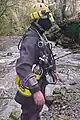 British cave diving style sidemounting harness, side view, with cylinders, weights and battery pack