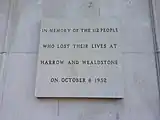 The disaster memorial stone plaque on display at the north entrance of Harrow and Wealdstone railway station