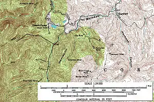 A black and white line-drawn map of a section of southeastern Arizona, oriented with north at the top of the page. Most of the labels denote mines, rivers, and peaks, and only a handful are plotted. While the labels are few, the map is entirely covered with wavy lines signifying the elevation and topography of the region. In the northeast corner of the map, near the banks of Harshaw Creek, lies the town of Harshaw. In the mountains to the southwest of town lie various area mines, including the Hardshell, Hermosa, Alta, American, Black Eagle, and Bender.