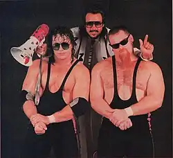 Bret Hart and Jim Neidhart with Jimmy Hart as The Hart Foundation in 1986